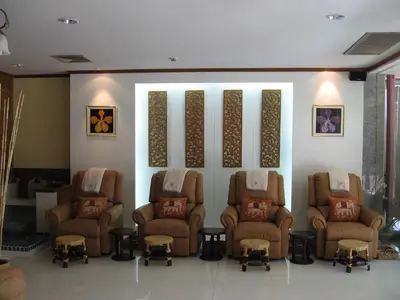 a waiting room with a bunch of chairs and a wall at Wall Street Inn, Bangkok in Bangkok