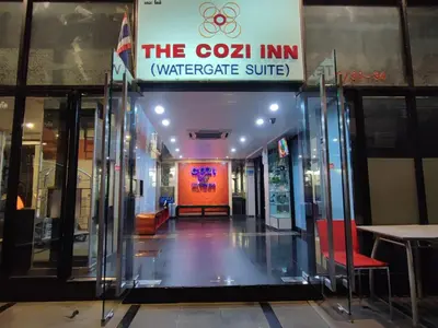 a building with a sign that reads the cozci inn watergate suite at Cozi Inn Hotel, Bangkok in Bangkok
