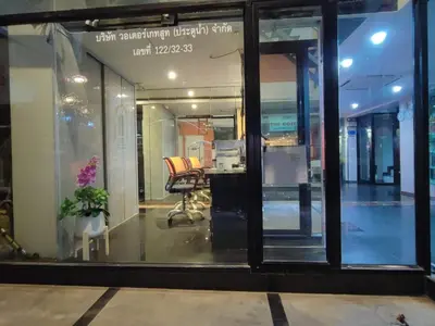 a window of a store with a desk in it at Cozi Inn Hotel, Bangkok in Bangkok