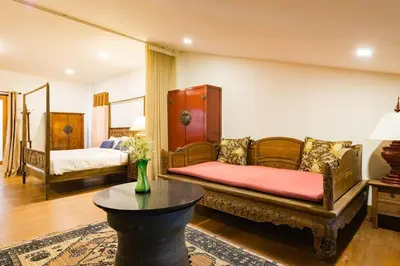 a living room with a couch and a table at Artisan's Antique House - Silom in Bangkok
