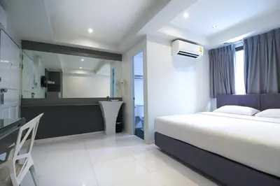 a hotel room with a bed and a bathroom at My Hotel Pratunam in Bangkok