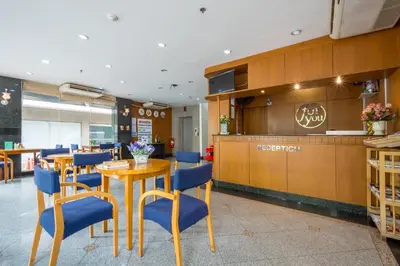 a restaurant with blue chairs and a table and a counter at For You Residence in Bangkok