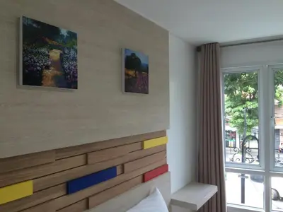 a bedroom with a wooden headboard with colorful drawers at For You Residence in Bangkok