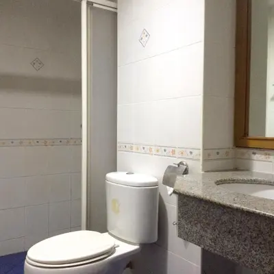 a bathroom with a toilet and a sink at For You Residence in Bangkok