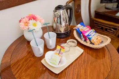 a table topped with cups and a plate of food at MIDO Hotel in Bangkok
