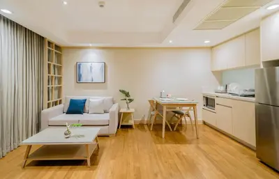 a living room with a couch and a table at Shama Petchburi 47 Bangkok in Bangkok