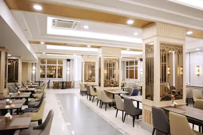 a restaurant with tables and chairs in a room at Asia Hotel Bangkok in Bangkok