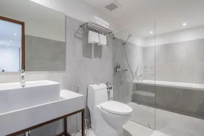 a bathroom with a toilet and a sink and a shower at True Siam Phayathai Hotel in Bangkok