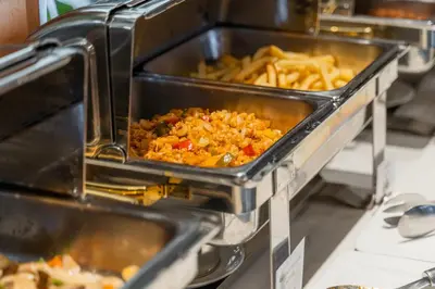 a buffet with some food and french fries at True Siam Phayathai Hotel in Bangkok