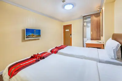 a bedroom with a white bed with a red ribbon on it at NASA BANGKOK - Airport Rail Link Ramkhamhang in Bangkok