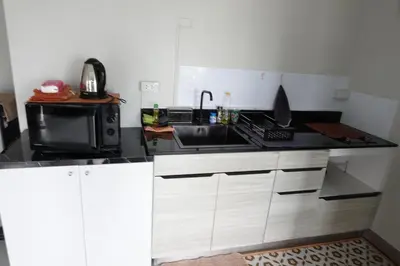 a kitchen with a sink and a microwave at Nice view over the heart of Bangkok in Bangkok