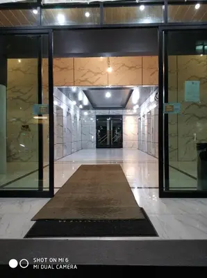 a hallway of a building with a rug in the middle at SKB Mansion close to MRT in Hua mark in Bangkok
