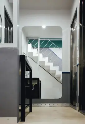 a staircase in a building with a painting on the wall at Tales Khaosan (Cafe & Hostel) in Bangkok