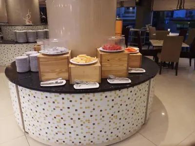 a table with plates of food on top at The Maruay Garden Hotel in Bangkok