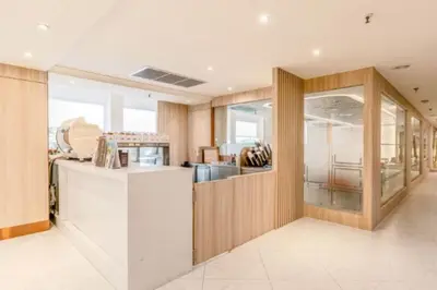 a kitchen with wooden walls and a white counter at The Maruay Garden Hotel in Bangkok