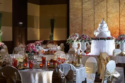 a table with a wedding cake on top of it at The Landmark Bangkok in Bangkok