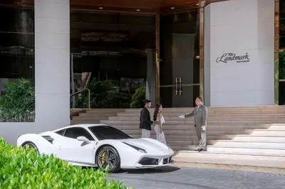a white car parked in front of a building at The Landmark Bangkok in Bangkok
