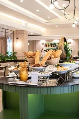 a buffet with plates of food on a table at Twin Towers Hotel in Bangkok