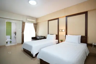 a hotel room with two beds and a bathroom at P-Park Suvarnabhumi in Bangkok