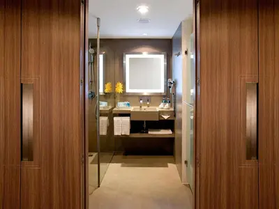 a bathroom with a sink and a shower and a mirror at Novotel Bangkok on Siam Square in Bangkok
