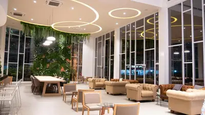 a lobby with tables and chairs and a christmas tree at Trang Hotel Bangkok - SHA Plus in Bangkok