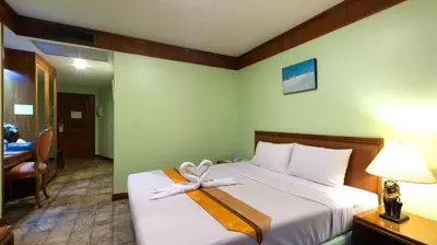 a hotel room with a bed with a bow on it at Silom Avenue Inn in Bangkok