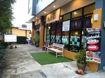a store front with a bench in front of it at @Home Residence in Bangkok
