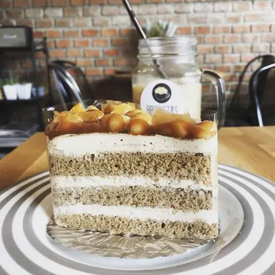 a cake sitting on a plate on a table at @Home Residence in Bangkok