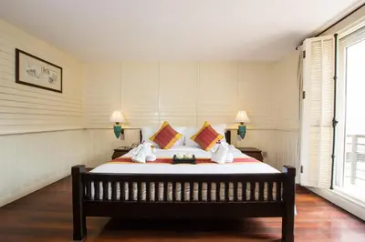 a bedroom with a large bed in a room at Buddy Lodge, Khaosan Road in Bangkok