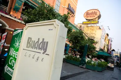 a sign for a bubbey food store on a city street at Buddy Lodge, Khaosan Road in Bangkok