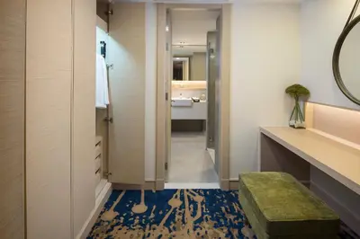 a bathroom with a mirror and a blue floor at Solitaire Bangkok Sukhumvit 11 in Bangkok