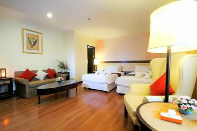 a hotel room with two beds and a couch at Princeton Bangkok in Bangkok