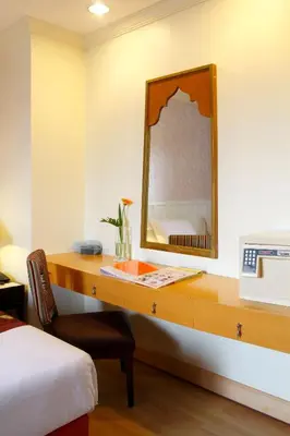 a bedroom with a desk with a mirror and a bed at Princeton Bangkok in Bangkok