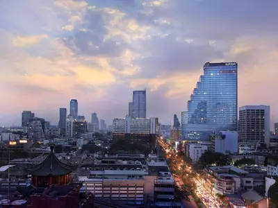a view of a city at night with buildings at Pullman Bangkok Hotel G in Bangkok