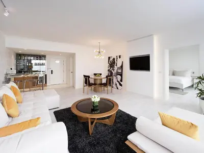 a living room with a white couch and a table at Pullman Bangkok Hotel G in Bangkok