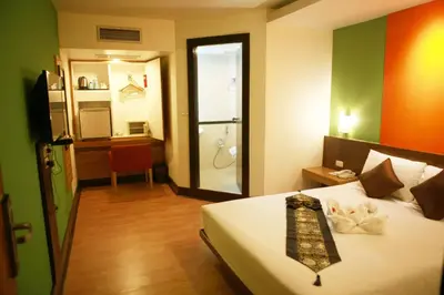 a bedroom with a bed with a tie on it at The Seasons Bangkok Huamark in Bangkok