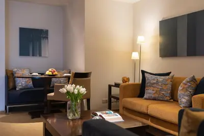 a living room with a couch and a table at lebua at State Tower in Bangkok