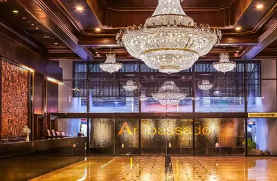 a lobby with a large chandelier and a store at Ambassador Hotel Bangkok in Bangkok