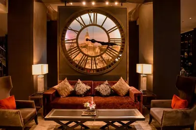 a living room with a couch and a large mirror at Shanghai Mansion Bangkok in Bangkok