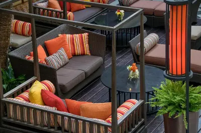 a row of chairs on a patio with colorful pillows at The Sukosol Hotel in Bangkok
