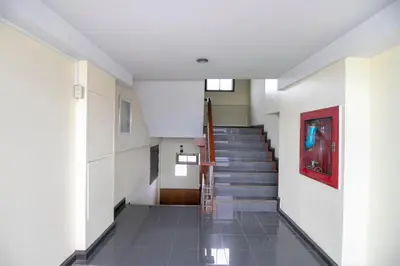 a hallway with a staircase in a building at Hotel Win Long in Bangkok