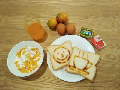 a table with two plates of breakfast foods with eggs and toast at The Chatbox Silom Hostel in Bangkok