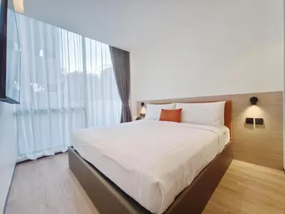 a bedroom with a large bed and a large window at Citichic Sukhumvit 13 by Compass Hospitality - Newly Renovated in Bangkok