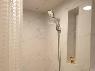 a shower with a shower head in a bathroom at Studio Ekamai in Bangkok