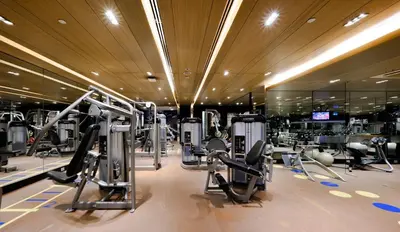 a gym with rows of treadmills and machines at Centara Grand at Central Plaza Ladprao Bangkok in Bangkok