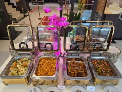 four trays of food on a table at Boss Suites Nana Hotel in Bangkok