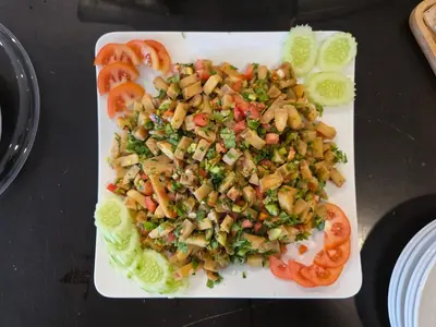 a plate of food with vegetables on a table at Boss Suites Nana Hotel in Bangkok