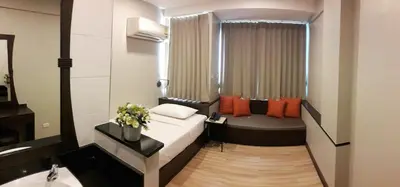 a small room with a bed and a sink in it at YWCA Hotel Bangkok in Bangkok