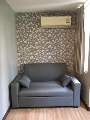 a living room with a couch and a air conditioner at YWCA Hotel Bangkok in Bangkok