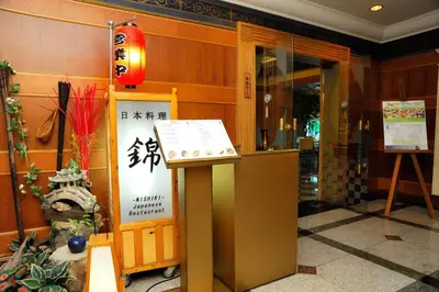 an entrance to a building with a sign on a podium at Golden Tulip Sovereign Hotel Bangkok in Bangkok